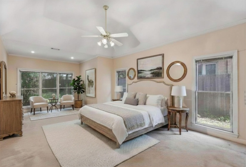 PRIMARY BEDROOM (25x14) – Generous primary suite highlighted by a coffered ceiling and adjoining 11X09 SITTING AREA, creating a private space to unwind. Virtually staged photo.