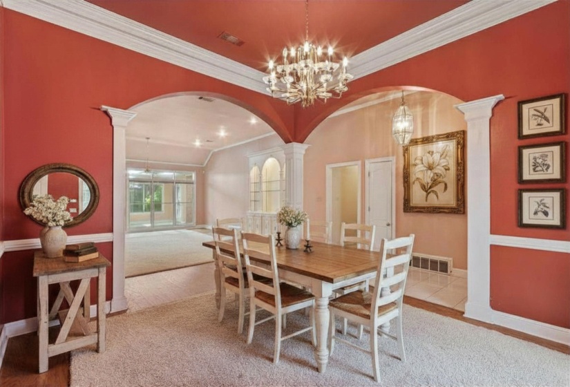 DINING ROOM (14x13) – Elegant formal dining room featuring hardwood flooring, crown molding, and chair rail accents, perfect for holiday gatherings and entertaining.  Virtually staged photo.