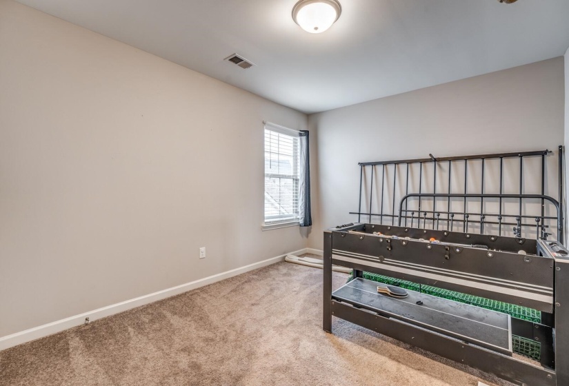 Bedroom with baseboards and light colored carpet