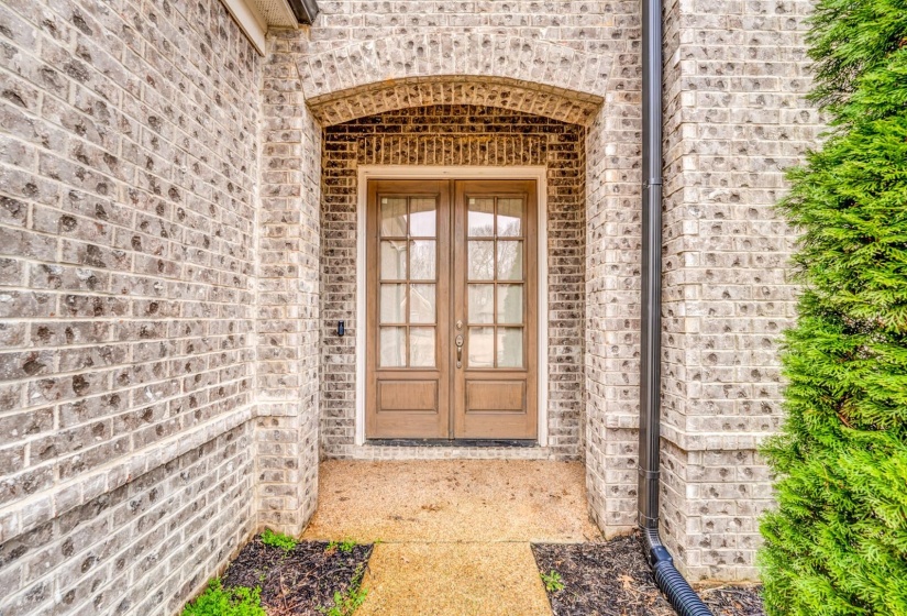 Entrance to property with brick siding and french doors