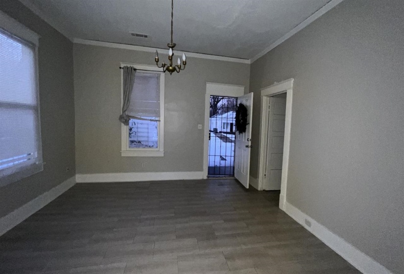 Light gray walls with white baseboards and crown molding
