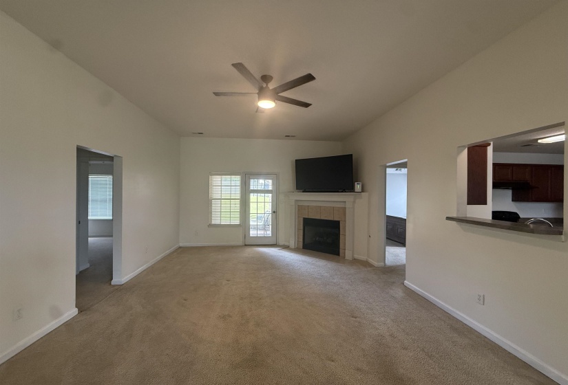 Living area featuring a fireplace with a light-toned mantel and tile surround