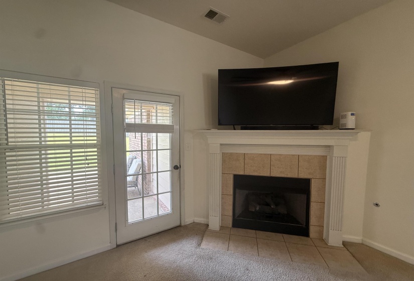 Corner fireplace featuring a white mantel, tile surround, and an integrated firebox