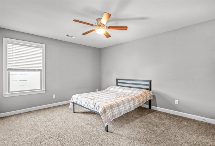 Carpeted room featuring a ceiling fan with integrated lighting, a window with white blinds, light gray wall paint, and white trim