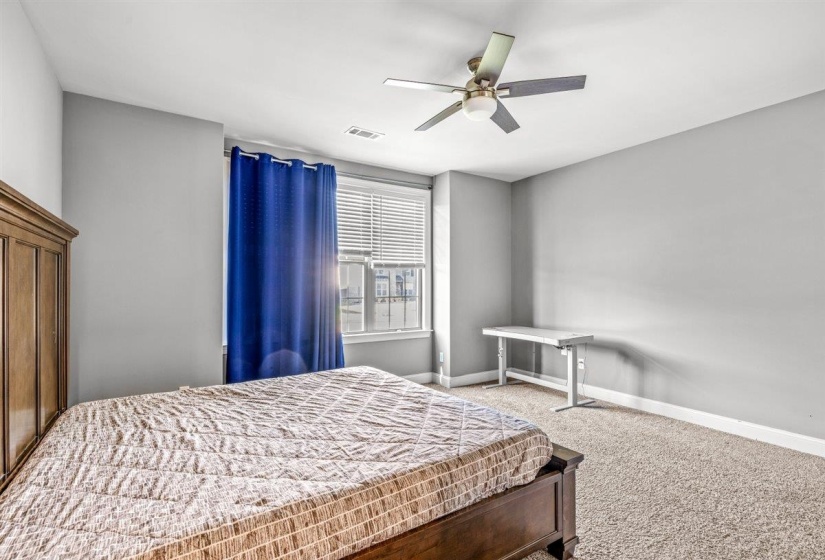 Carpeted bedroom with neutral wall tones