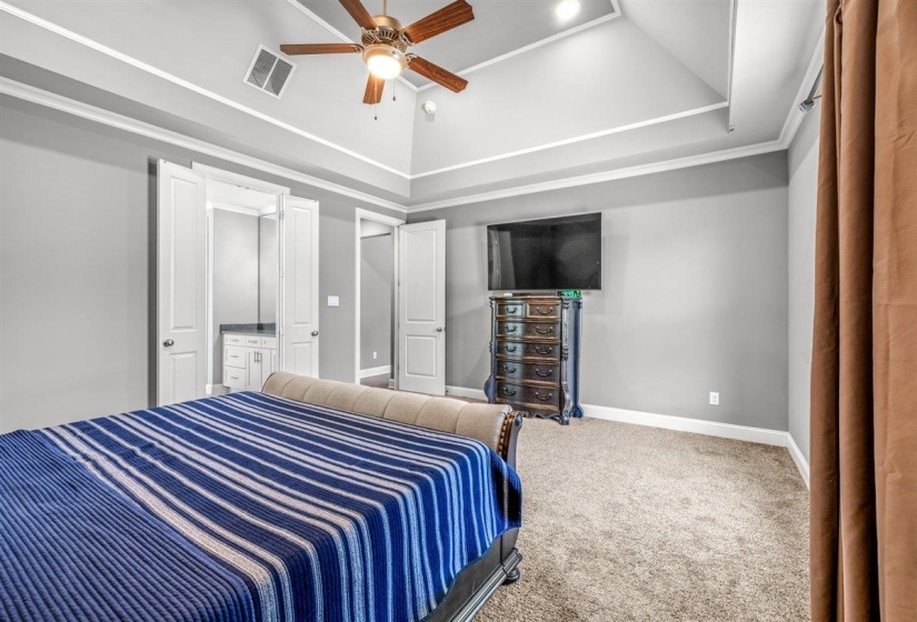 Spacious bedroom featuring vaulted ceilings, a ceiling fan with integrated lighting, recessed lighting, and soft carpet flooring