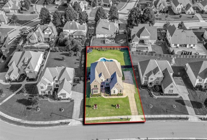 Expansive property featuring a multi-story residence with a large backyard, in-ground swimming pool, and mature landscaping