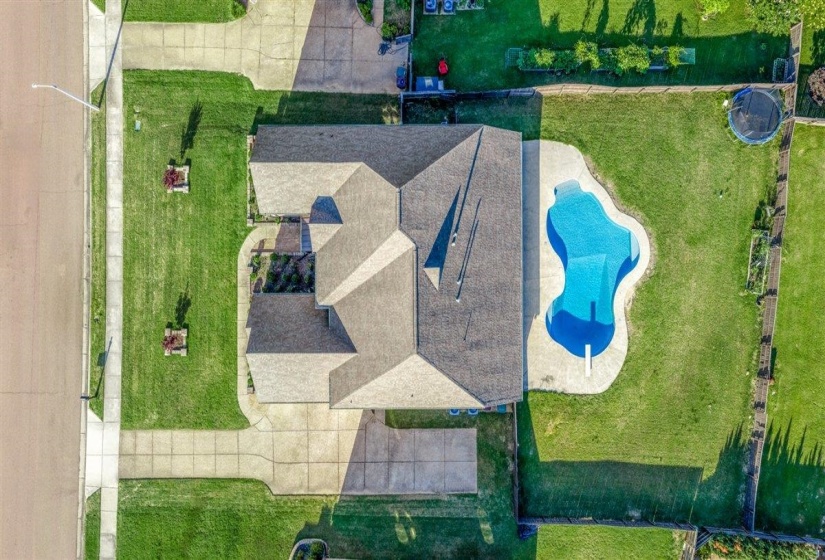 Single-story residence featuring a multi-gabled roofline and a private backyard swimming pool with an integrated diving board