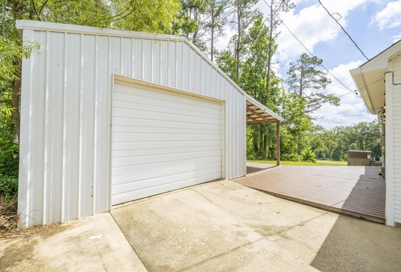 White metal-sided garage with roll-up door