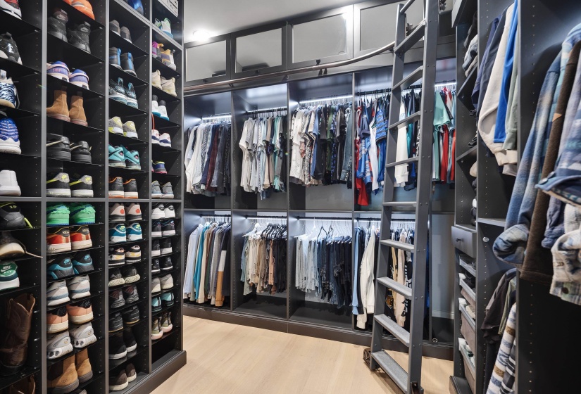 Custom closet system featuring extensive shelving and hanging rods