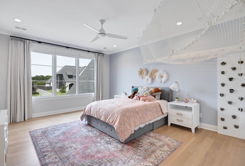 Light wood-finish flooring complements the light blue wall paint