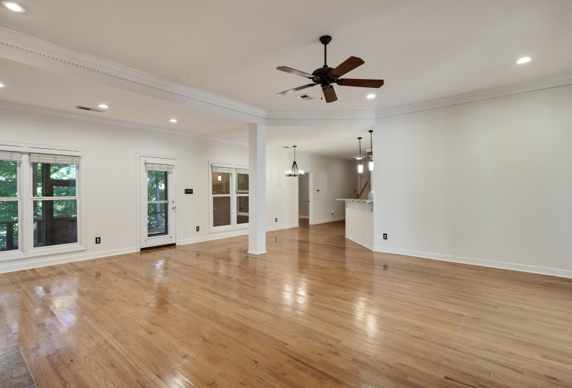 Spacious living area featuring wood-finish flooring, recessed lighting, and a ceiling fan