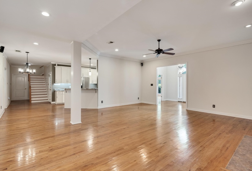 Expansive main living area featuring polished wood flooring, recessed lighting, and crown molding