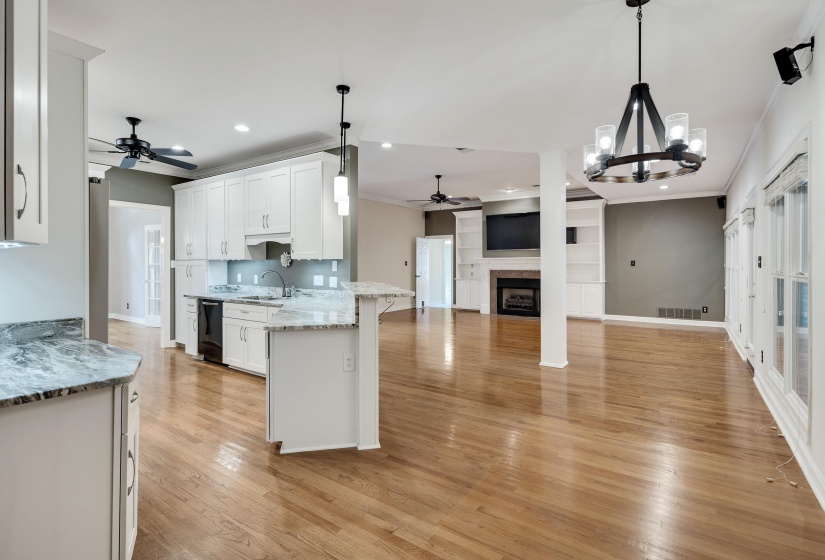 Open-concept kitchen and living area featuring wood-finish flooring