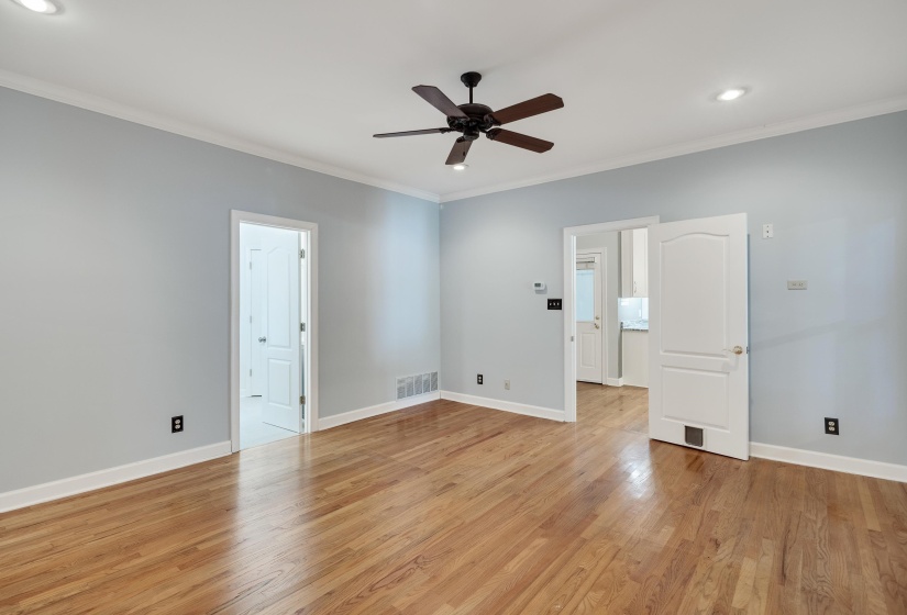 Spacious room featuring wood-finish flooring and light blue walls
