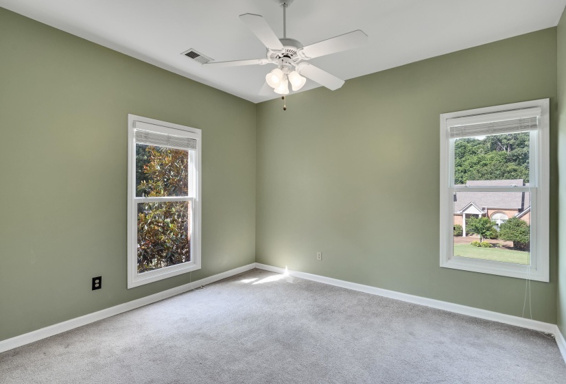 Light green walls with white trim and a ceiling fan with integrated lighting