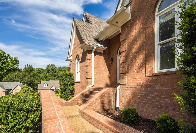 Brick exterior featuring arched windows and a gabled roofline