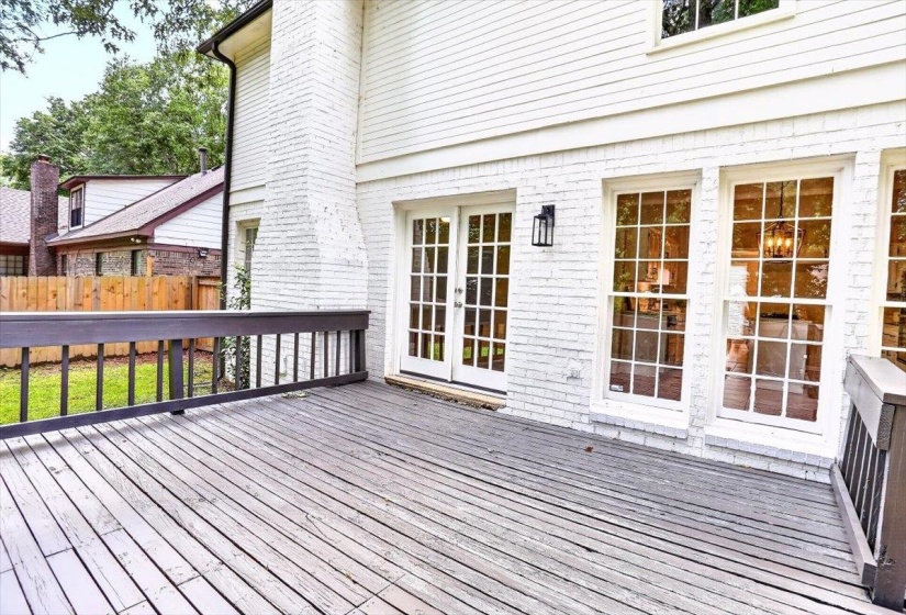 Expansive outdoor deck with dark wood-finish railing