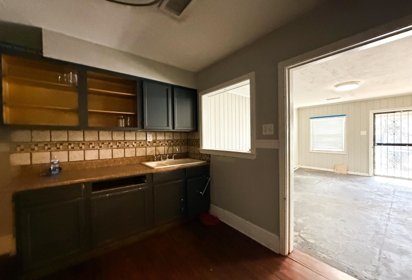 Bar featuring baseboards and open shelves