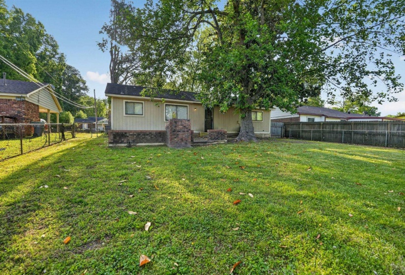 Back of property with a patio, a fenced backyard, and brick siding