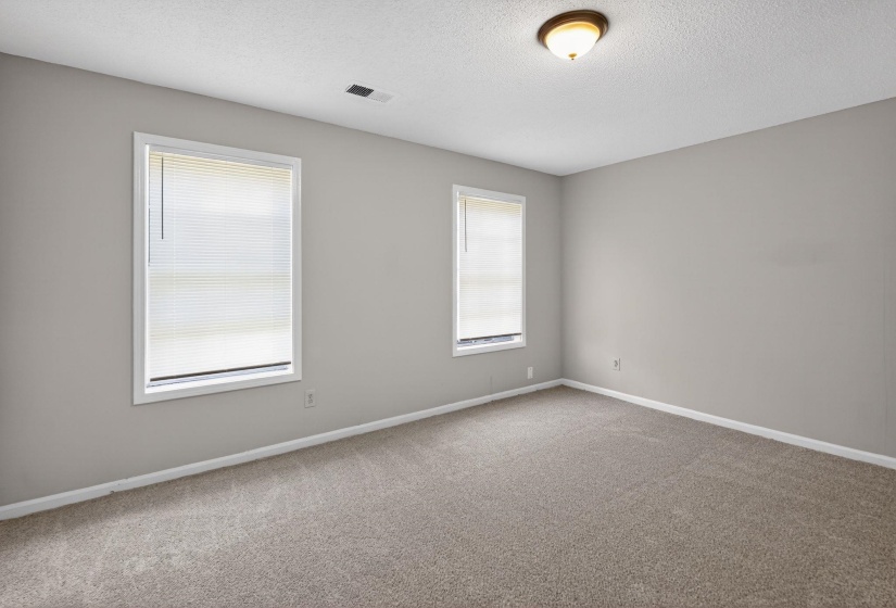 Unfurnished room with carpet and a textured ceiling