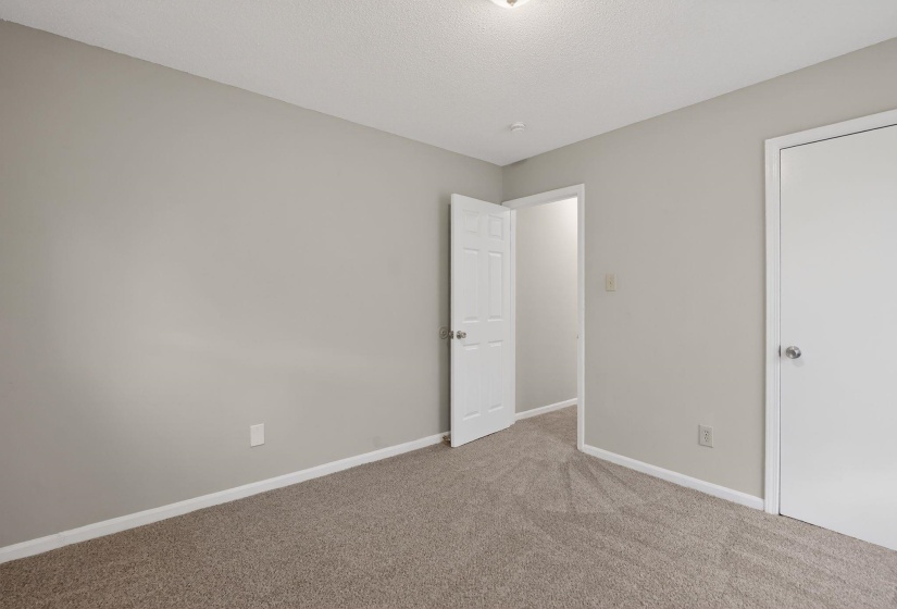 Unfurnished bedroom featuring carpet flooring and a textured ceiling