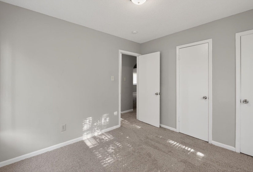 Unfurnished bedroom featuring baseboards and carpet flooring