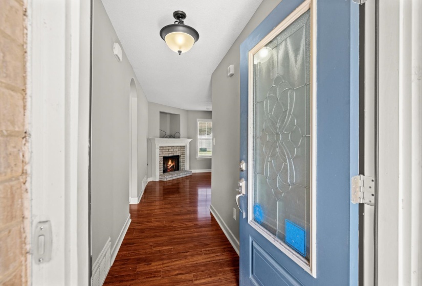 Entryway featuring a decorative glass-paneled door, wood-finish flooring, and a ceiling-mounted light fixture