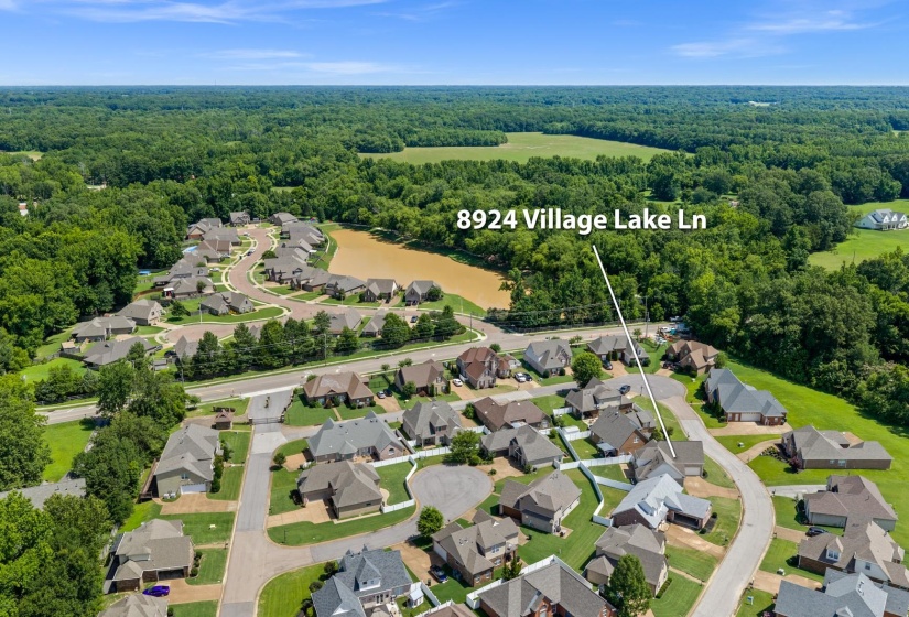 Aerial perspective showcasing a residential community with a central water feature