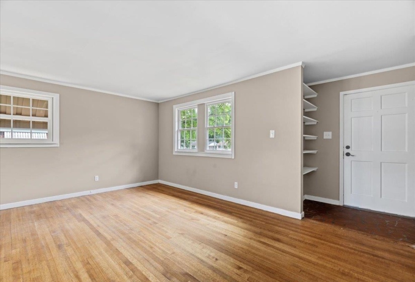 Interior space featuring wood-finish flooring, neutral wall paint, and white trim