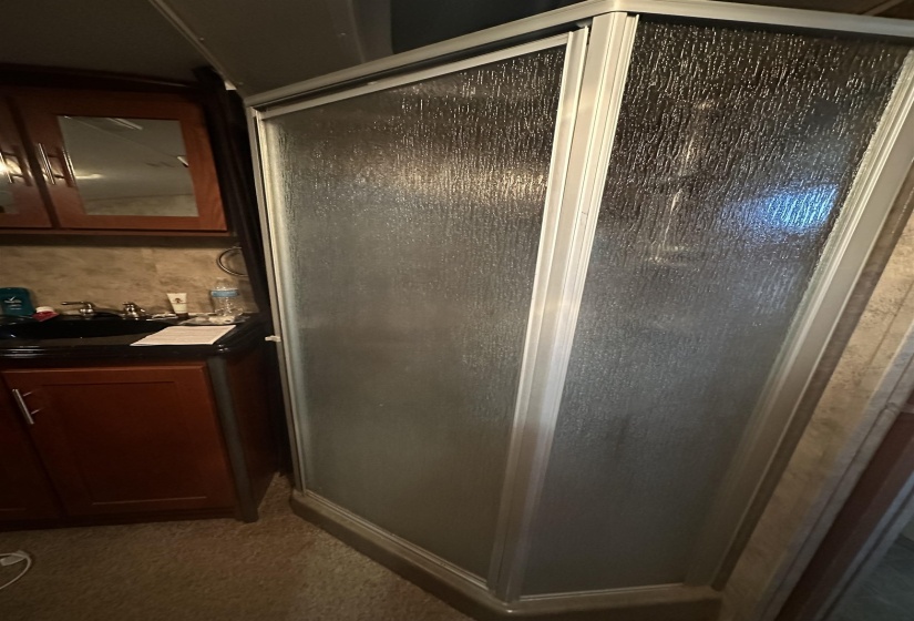 Bathroom with a stall shower and vanity