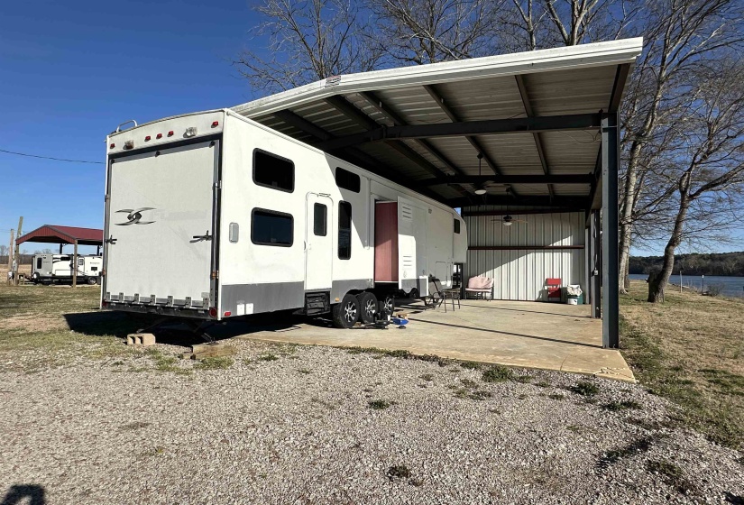 View of outdoor structure featuring gravel driveway