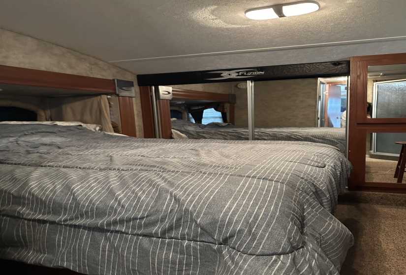Bedroom with vaulted ceiling and carpet floors