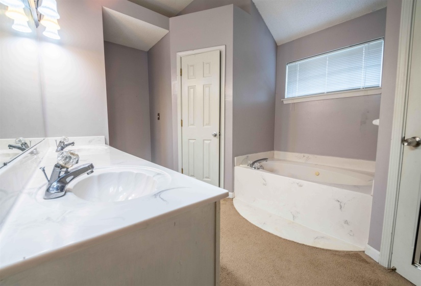 Dual vanity with white undermount sinks, chrome faucets, and a white countertop