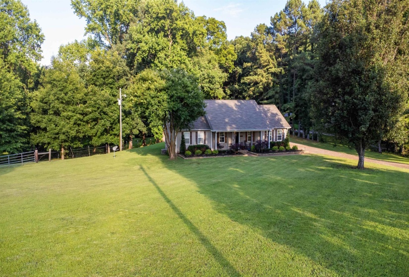 Ranch-style residence featuring a covered front porch with white columns