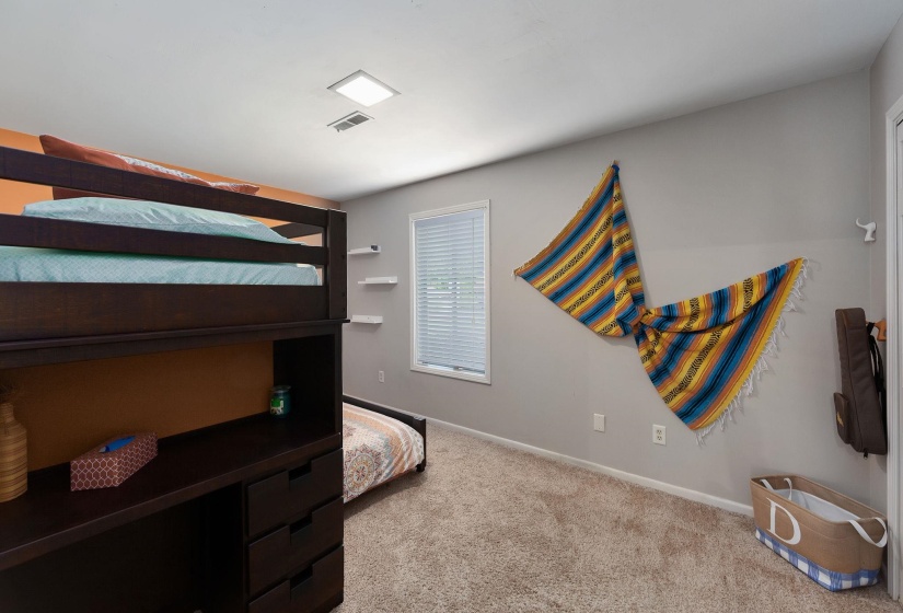 Bedroom featuring a window with blinds, recessed lighting, and neutral-toned carpeting