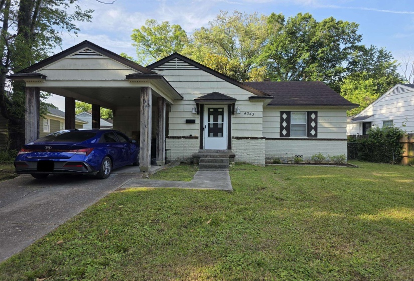 Single-story residence featuring a covered carport, a front entry with a small portico, and a mixed exterior of siding and painted brick