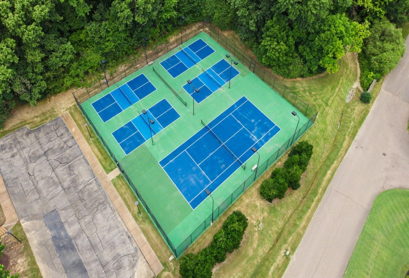 Recreational court area featuring one full-size tennis court and three pickleball courts
