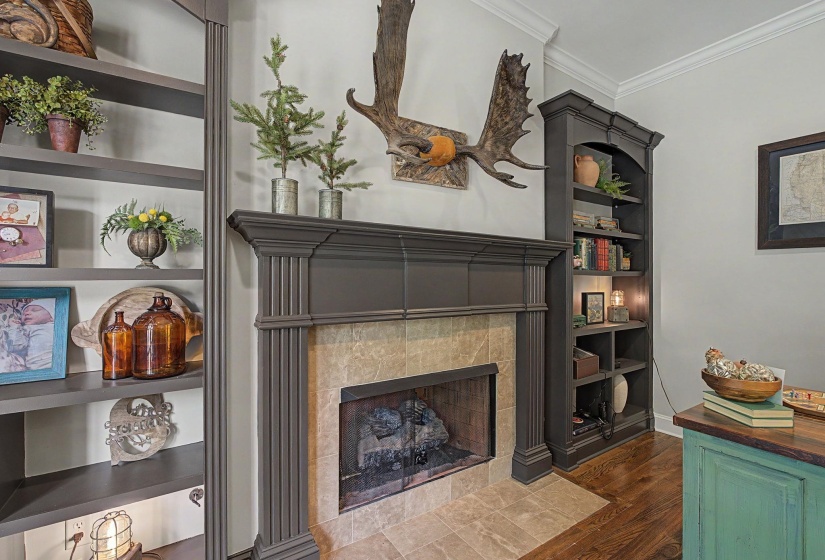 Custom fireplace with decorative mantel, tile surround, and hearth