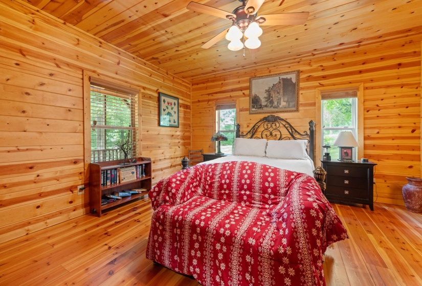 Interior room featuring natural wood plank walls and wood-finish flooring