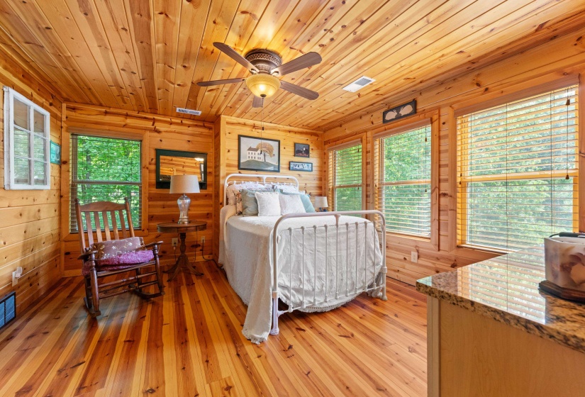 Room with extensive wood-finish wall paneling, ceiling planks, and wood-finish flooring