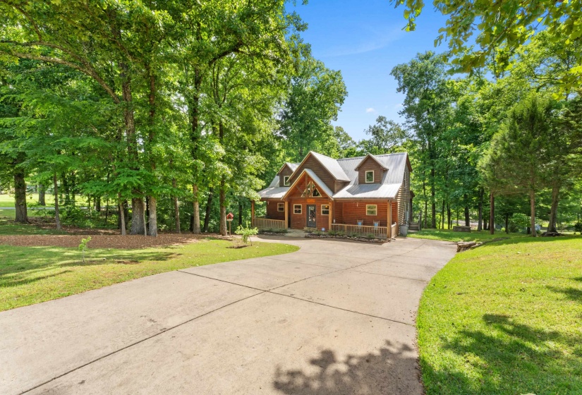 Wood-sided home featuring a covered front porch and dormer windows