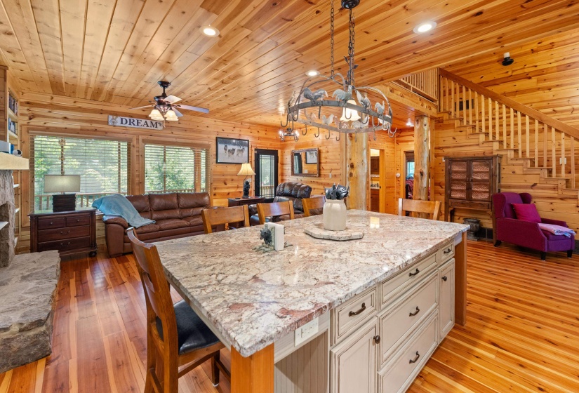 Central island featuring a light-toned granite countertop and cream cabinetry
