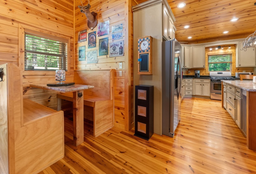 Wood-paneled interior featuring a built-in banquette dining area with a granite-style tabletop