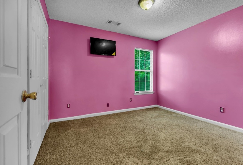 Room featuring a single-pane window, wall-to-wall carpeting, and a flush mount ceiling light fixture