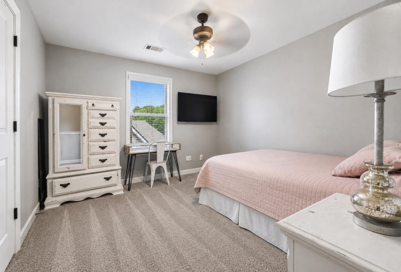 Carpeted room with a ceiling fan, window with blinds, and light gray wall paint