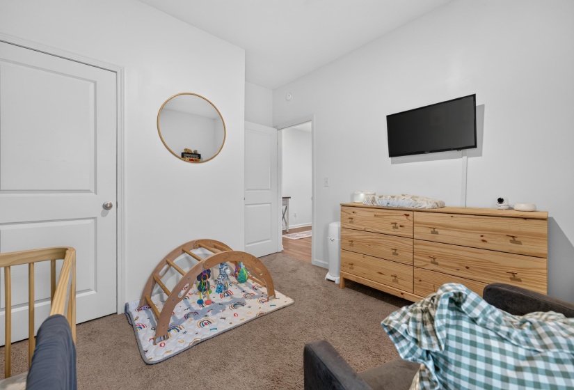 White interior walls, two panel interior doors, and neutral carpet flooring
