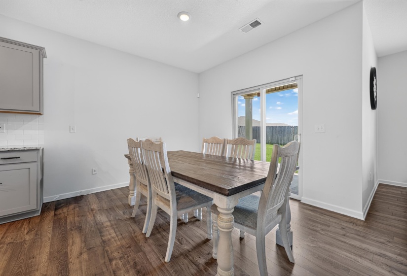 Dining area featuring wood-finish flooring and a sliding glass door