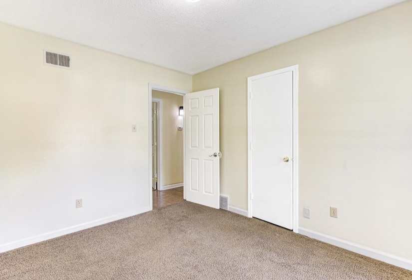 Carpeted interior space with neutral wall color and white trim