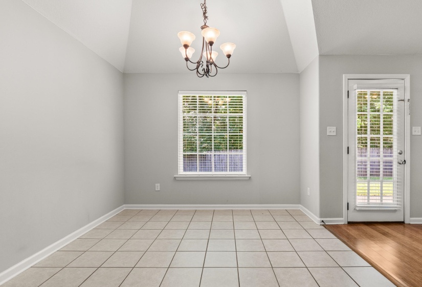 Interior room with vaulted ceilings and a bronze chandelier